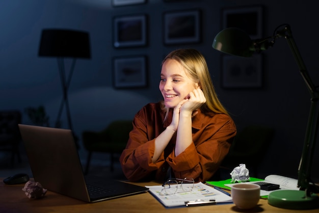 Beautiful smiling woman looking at laptop