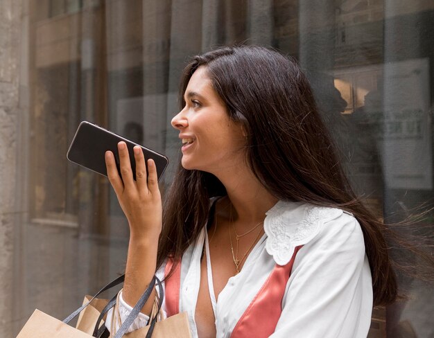 Beautiful smiling woman with smartphone