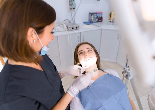 Beautiful smiling young woman having dental check up