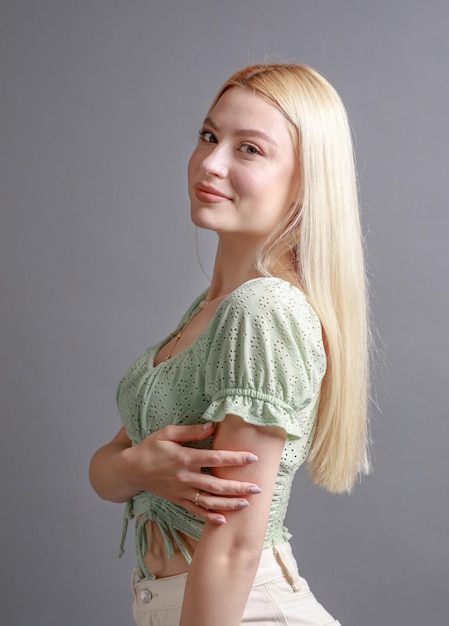 Beautiful smiling young woman with perfect skin face natural beauty concept isolated on grey studio background