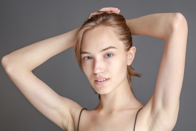 Beautiful smiling young woman with perfect skin face natural beauty concept isolated on studio background