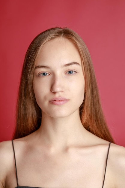 Beautiful smiling young woman with perfect skin face natural beauty concept isolated on studio background