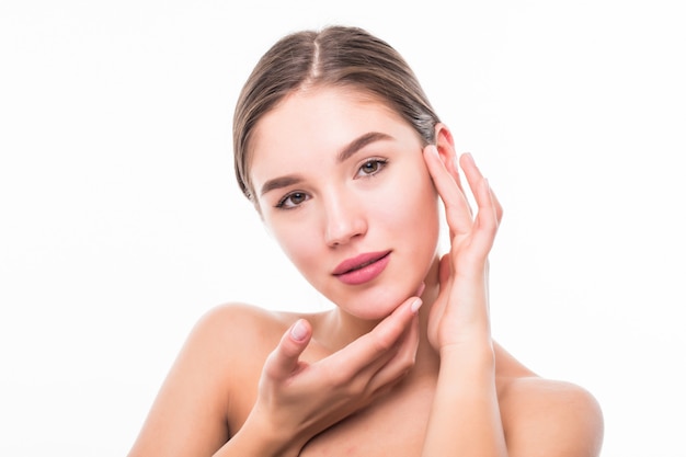 Beautiful spa young woman touching her face isolated on white wall.