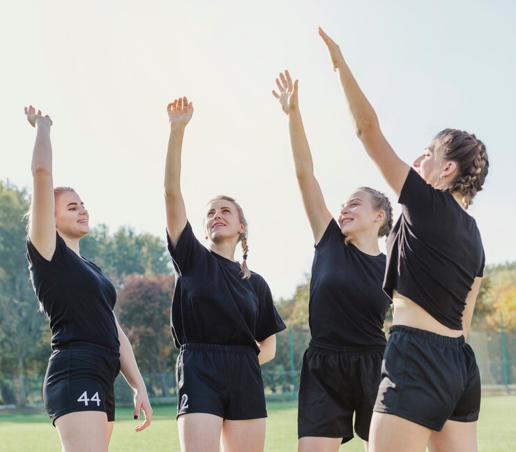 Free Photo beautiful sportive girls raising hands