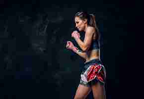 Free photo beautiful sportive woman is warming up before training while posing for photographer.