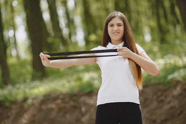 Beautiful sports girl in a summer forest