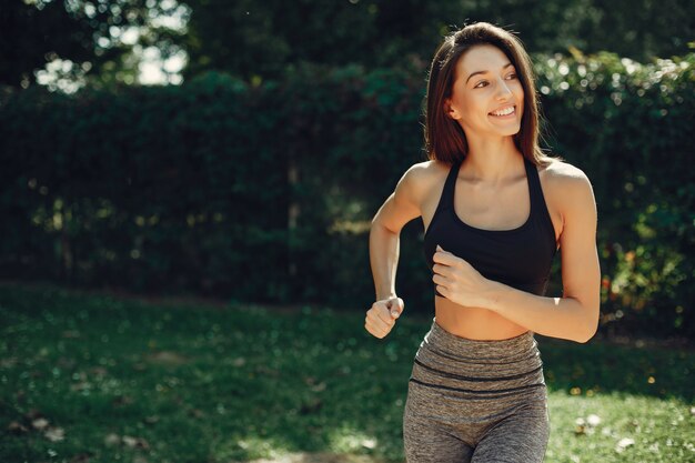 Beautiful sports girl in a summer park