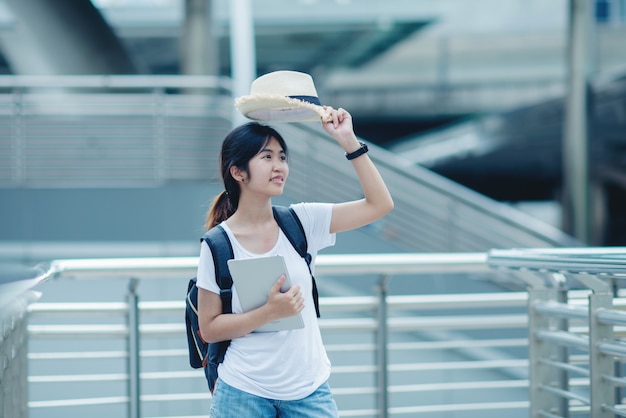 Beautiful student girl smiling with laptop and bag,Education concept