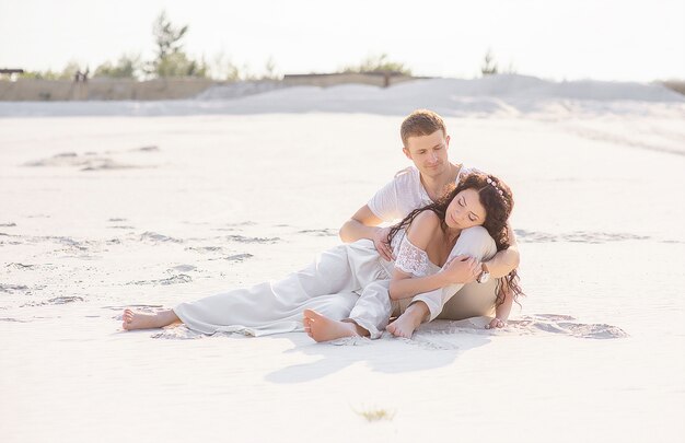 Beautiful stylish couple posing on the beach