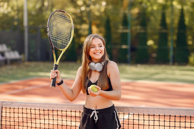 Beautiful and stylish girl on the tennis court