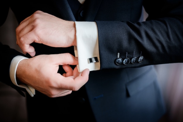 Beautiful stylish groom's cufflinks on the shirt