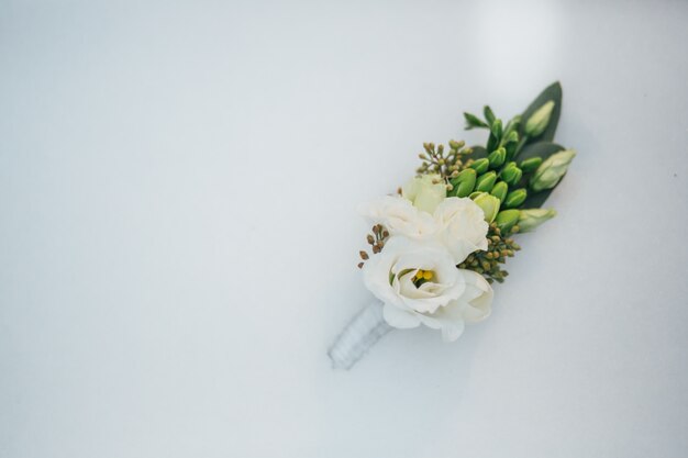 Beautiful stylish wedding boutonniere on the snow