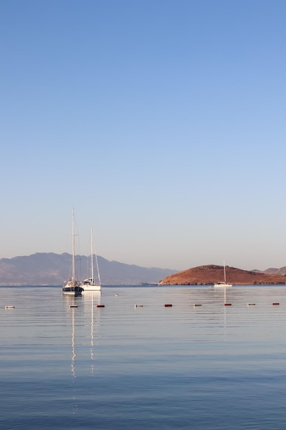 Beautiful sunrise on the aegean sea with islands mountains and boats high quality photo Premium Photo