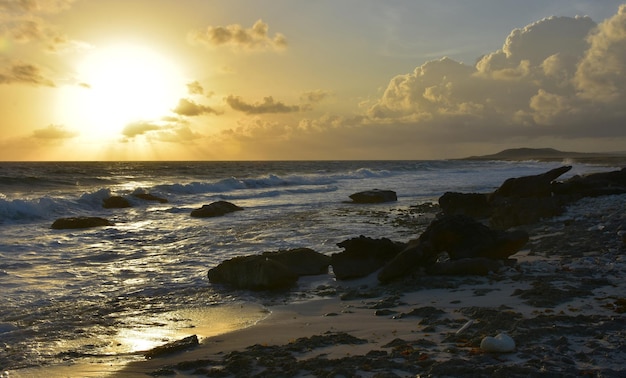 Beautiful sunrise over the ocean and rocks in Aruba.