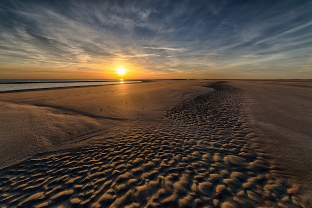 Beautiful sunset at the beach creating the perfect scenery for evening walks at the shore