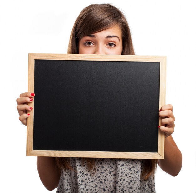 Beautiful teenager behind a blackboard