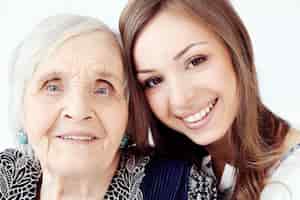 Free photo beautiful teenager girl and her grandmother, family portrait