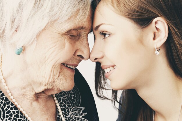 Beautiful teenager girl and her grandmother, family portrait