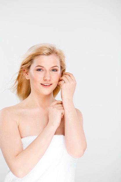 Beautiful tender woman in bath towel smiling gentle