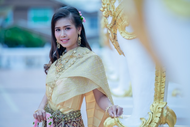 Beautiful Thai woman in traditional dress costume in Phra That Choeng Chum Thailand temple