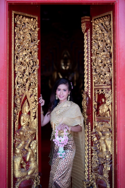 Free photo beautiful thai woman in traditional dress costume, temple thailand