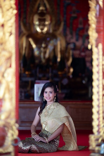 Beautiful Thai woman in traditional dress costume, temple thailand