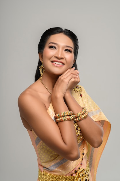 Beautiful Thai woman wearing a Thai dress and a happy smile.