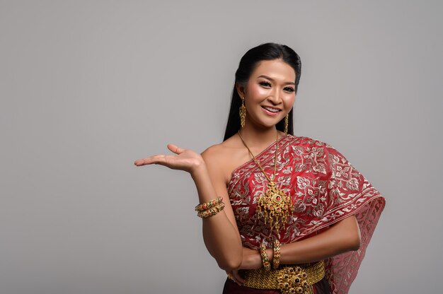 Beautiful Thai woman wearing a Thai dress and a happy smile.