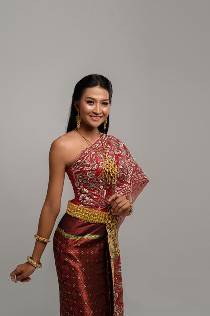 Beautiful Thai woman wearing a Thai dress and a happy smile.