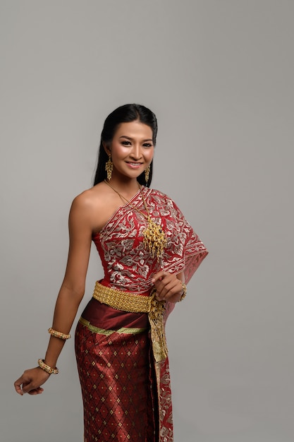 Beautiful Thai woman wearing a Thai dress and a happy smile.