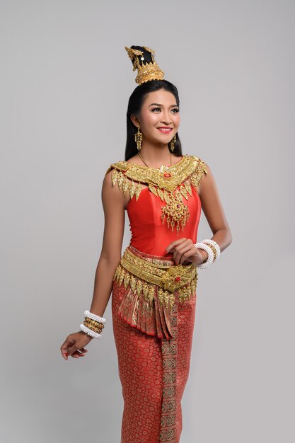 Beautiful Thai woman wearing Thai dress and looking at the top