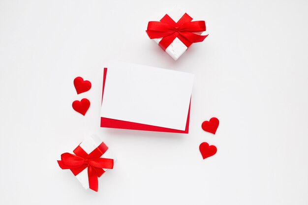 Beautiful top view of empty greeting card for Valentines on white