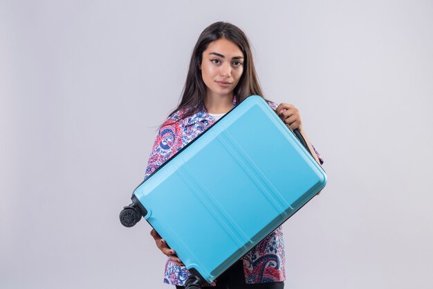 Beautiful tourist woman holding travel suitcase looking confident ready to travel concept standing 