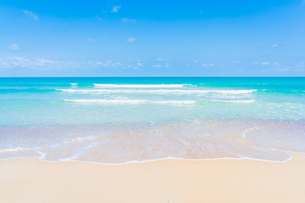 Beautiful tropical beach sea ocean with white cloud and blue sky background for travel vacation trip