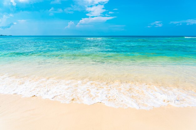 Beautiful tropical empty beach sea ocean with white cloud on blue sky background