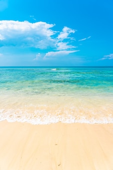 Beautiful tropical empty beach sea ocean with white cloud on blue sky background