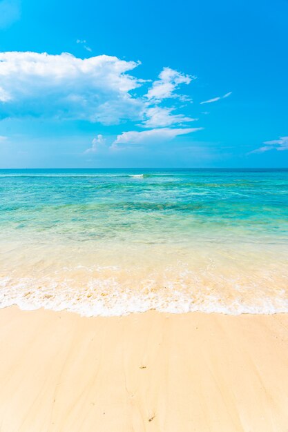 Beautiful tropical empty beach sea ocean with white cloud on blue sky background