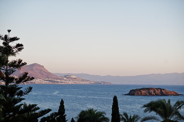 Beautiful tropical sea bay with palms Scenic landscape with mountain islands and blue lagoon on Aegean sea Exotic scenery Popular landmark famous destination of Bodrum Turkey