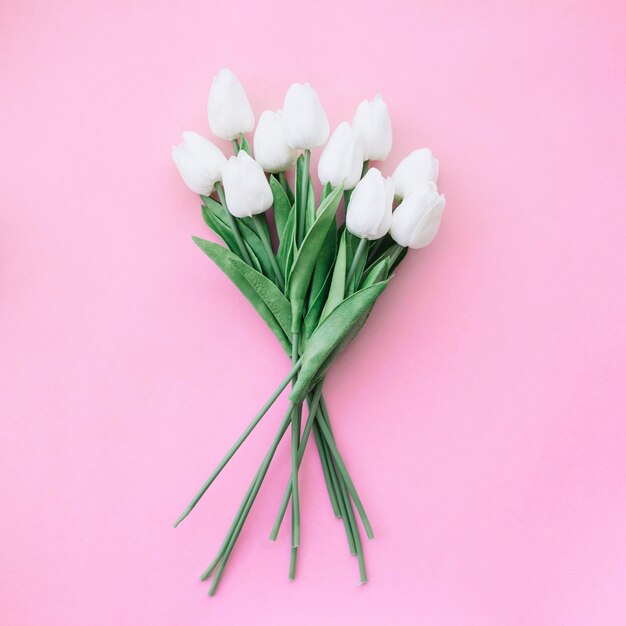 beautiful tulips bouquet on pink background