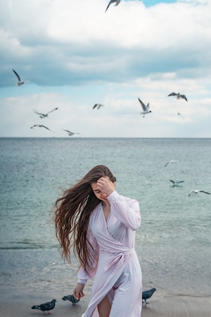 Beautiful unusual woman walking on the beach