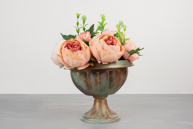 Beautiful vase of pink roses on grey surface