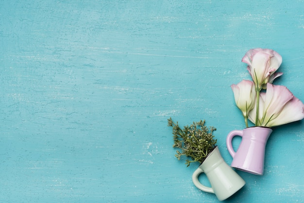 Beautiful vases on blue textured wooden background