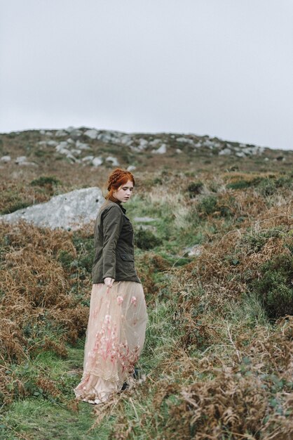 Beautiful vertical picture of a ginger female with a pure white skin