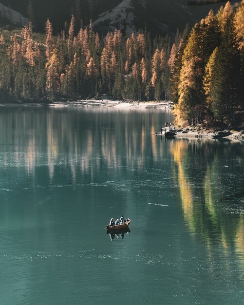 Beautiful vertical shot of people sailing in the lake