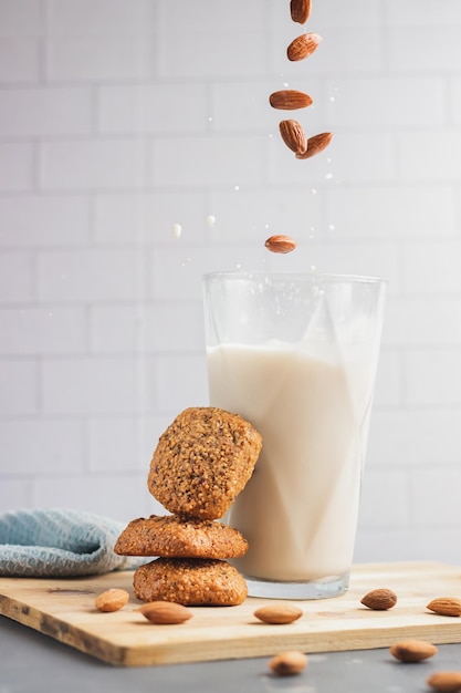 Beautiful view of almonds falling into a cup of milk