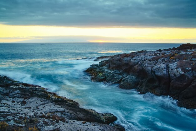 beautiful view from the cliff of mountain to the ocean with blue sky and clouds