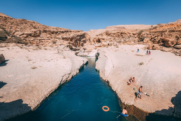 Beautiful view of a river going through the mountains under the blue sky