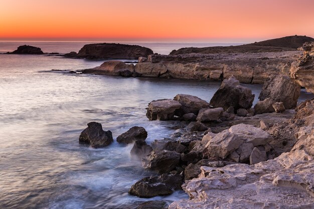 Beautiful view of sunrise on the coast of Escullos, Natural Park of Cabo de Gata, Spain
