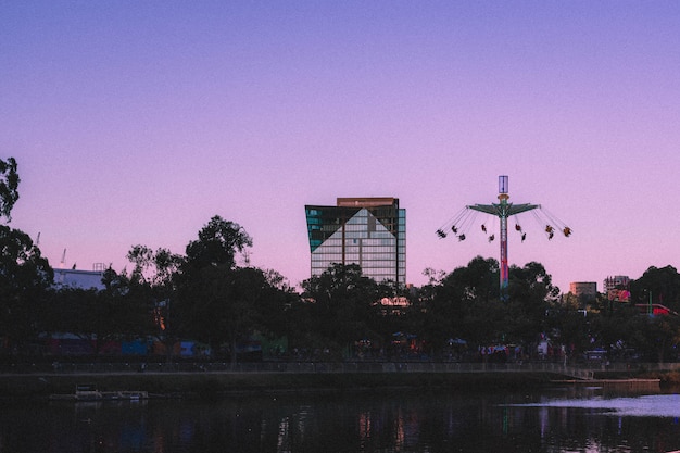 Free photo beautiful view of a tall glass business building with tall swings on the side