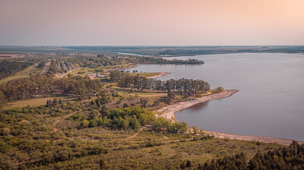 Beautiful view of trees near tranquil lake under a sunset background